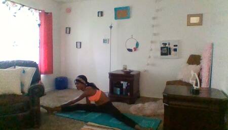 Barefoot in yoga pants stretching...