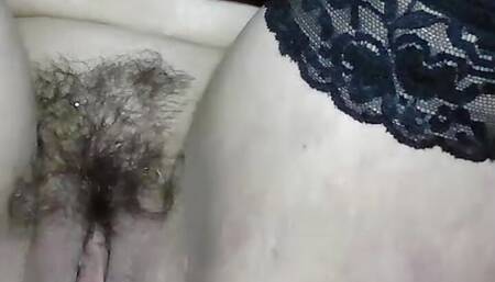 Massaging a wet pussy with a hairy pubis