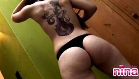 Lesbian nina stripping off beside the green wall