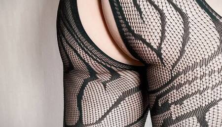 Crossdresser in lace black lingerie plays with a vibrator locked in a chastity cage
