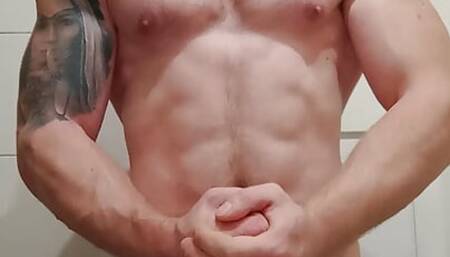 Fitness muscular guy is showing muscles