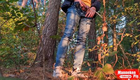 Guy pissing in the forest under a tree