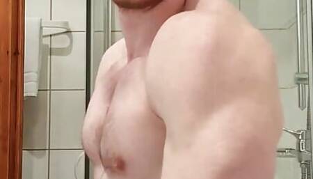 Muscular guy cleaning body in hotel