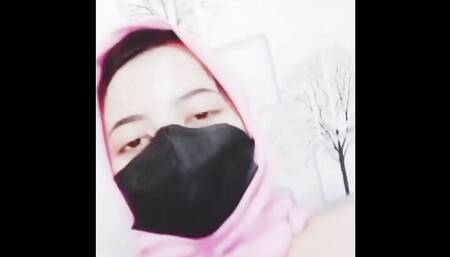 hijab woman playing with dildo in room
