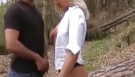 A magnificent blonde girl from Germany riding and sucking two cocks in the woods