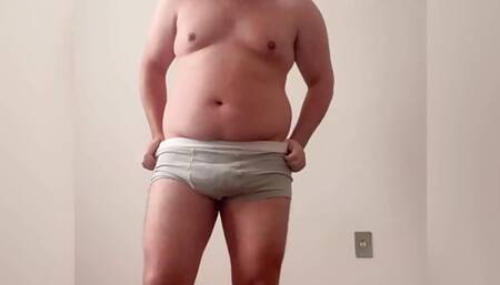 Chubby boy taking off clothes