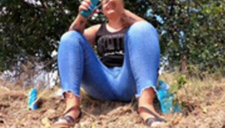 Pissing trough her jeans while talking on the phone and on a dirt road in the middle of nowere