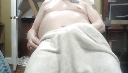 jerking off under a towel.