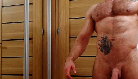 A powerful bear, a hairy bodybuilder, shows off his muscles and jerks off the big cock to cum the sweet sperm