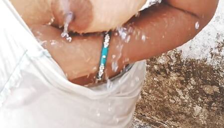 Village bhabhi bathing outdoor and showing sexy boobs