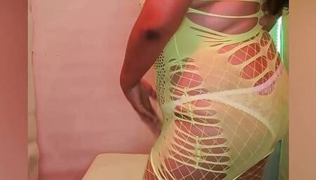 Chubby wife dancing in lingerie with a rich fishnet bodysuit and phosphorescent green stockings