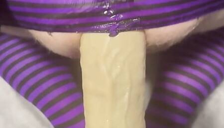 Sissy in chastity taking large dildo stretching her ass