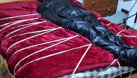 Man in sleepsack tormented by woman 1-BBW domination,BBW bondage,man in bondage,male bondage,man tied up,leather sleepsack,sleep sack,amateur, bound and gagged man,bed bound,