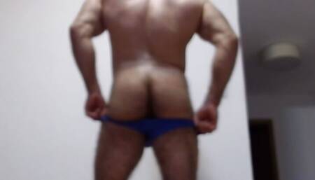 The powerful hairy bodybuilder does a striptease, poses, dances and shows a hairy hole in the ass from very close up