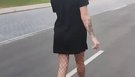 A slim trans girl shows her little ass in public.