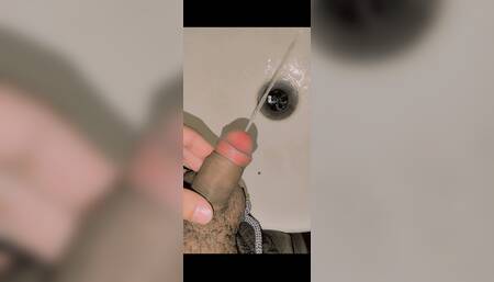 Young boy pissing in washroom