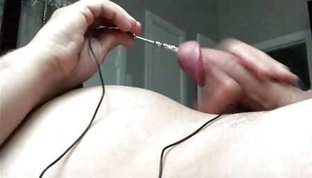 Cuckold inserts rod in penis and cums