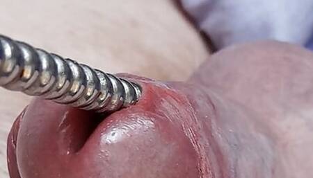 Sounding with a close up cum load through penis plug