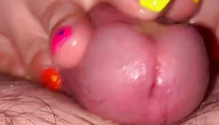 Tickling teasing colourful neon toes rubbing on a big head