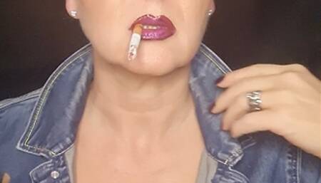 Smoker MILF in denim with big clevage smokes close up naughty seductive her Camel 100*sunglasses*glossy lips