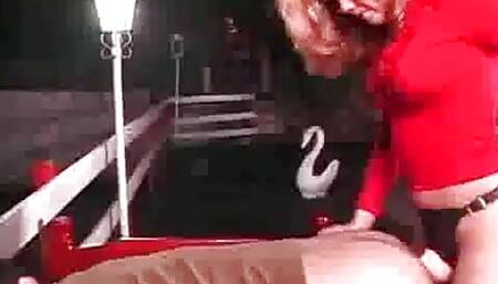 Pegging couple have strap-on fun outdoor.