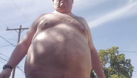 Fat guy getting naked outside