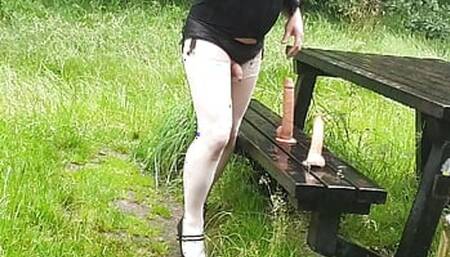 Crossdressing slut Maid in a public picnic area