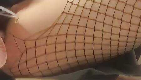 Intense masturbation of a girl wearing a fishnet