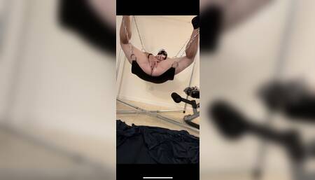 Riding a dildo in a sling