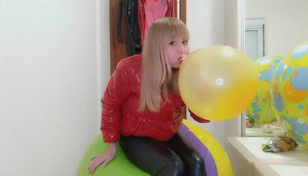 Alla rides on a big beach ball and wears a glossy down jacket and leather leggings and inflates a balloon with her mouth!!!