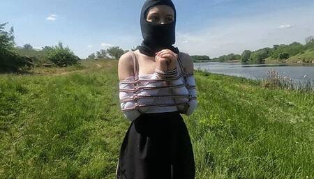 Tickling the feet of a bound girl