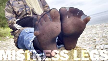 Sexy feet in black nylon socks wiggling toes at the seashore (MP4 HD)