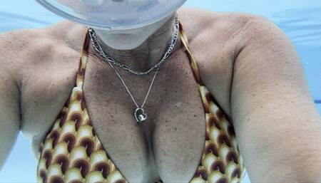 Carissa doing pool surface acrobatics in public with the pool noodles