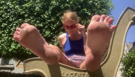 Dirty soles tease on a bench