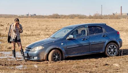 CARSTUCK Wet and muddy road to the village