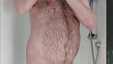 Hairy chastity bear showers and fingers his hole
