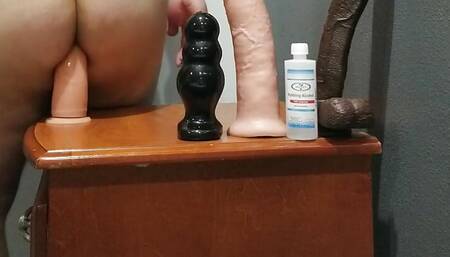 Super Fat Ass sits on large dildos.