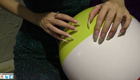 Nails scratching, puncture and destroying beach balls