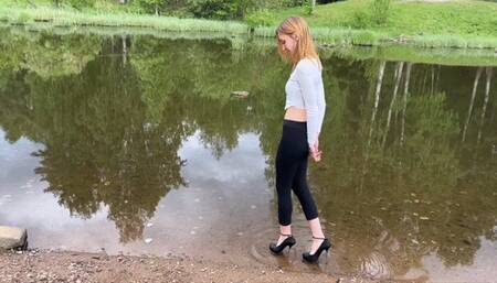 a beautiful girl in high heeled shoes walks on the beach, then she tries to climb the mountain