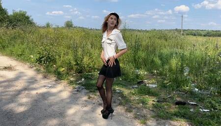 girl dressed as a policeman in stockings and high-heeled shoes is looking for a criminal, she steps on mud and puddles