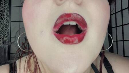 Shiny red lips tease