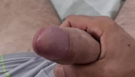 Jerking cock on the bed