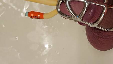 Pissing with catheter locked in chastity cage