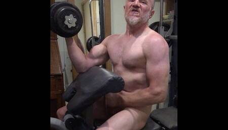 Arrogant gay bodybuilder does dumb-bell curls while jerking off and gets turned on by his big muscles and shoots a load!