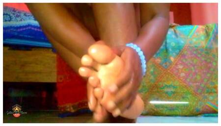 Ebony Goddess massages oil into beautiful feet and soles