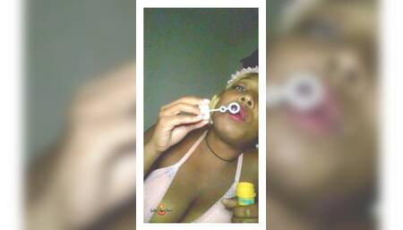 Ebony Goddess blowing bubbles