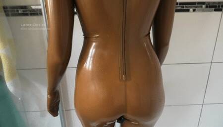 Taking off the sweaty golden rubber doll suit