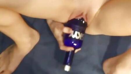Skinny slut fucks a vodka bottle leaving her gaping pussy wide open