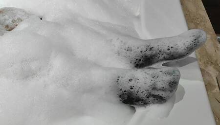 taking down black pantyhose at bathtub