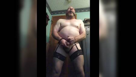 Brandon Hegsted cums wearing a garter belt, thigh highs, panties and handcuffs
